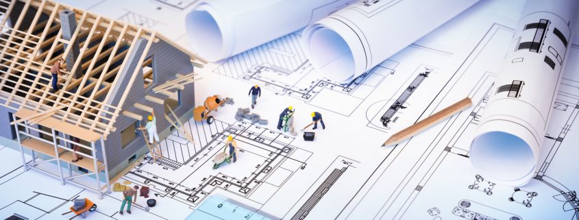 house under construction on blueprints - building project